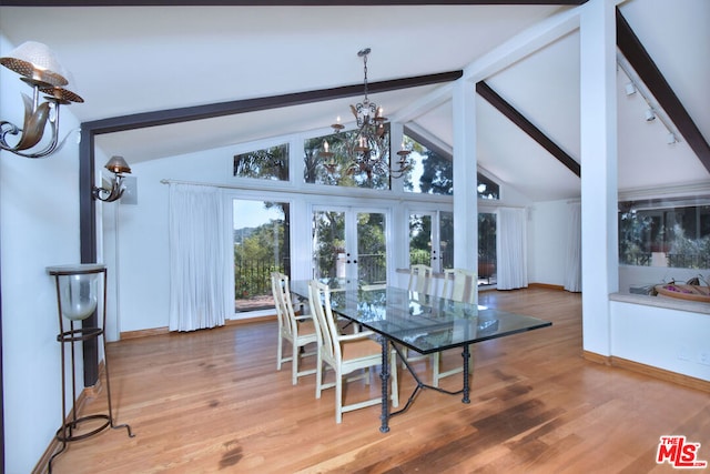 dining room featuring french doors, beamed ceiling, wood-type flooring, and a notable chandelier