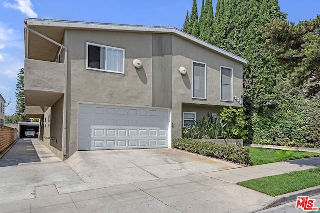 view of front of house featuring a balcony and a garage