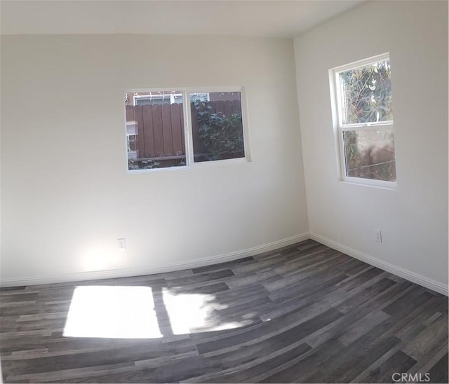 spare room featuring dark hardwood / wood-style flooring