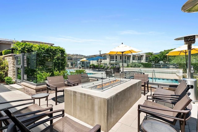 view of patio / terrace featuring a community pool and an outdoor fire pit