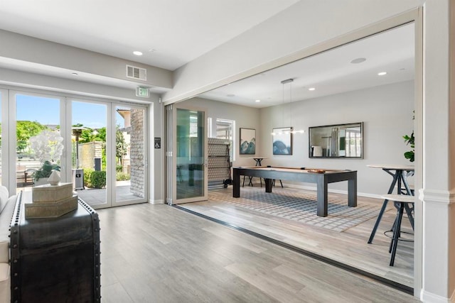 recreation room featuring light hardwood / wood-style flooring, billiards, and french doors