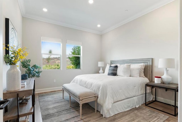 bedroom featuring ornamental molding and hardwood / wood-style floors