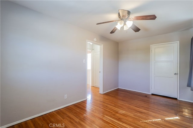 empty room featuring wood-type flooring and ceiling fan