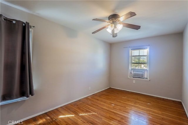 empty room featuring ceiling fan and light hardwood / wood-style flooring