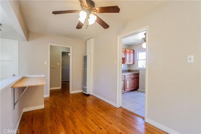 spare room featuring light hardwood / wood-style flooring and ceiling fan