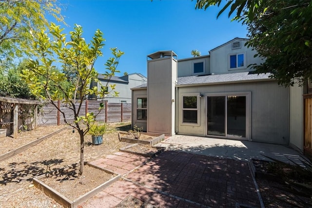 rear view of property featuring a patio area