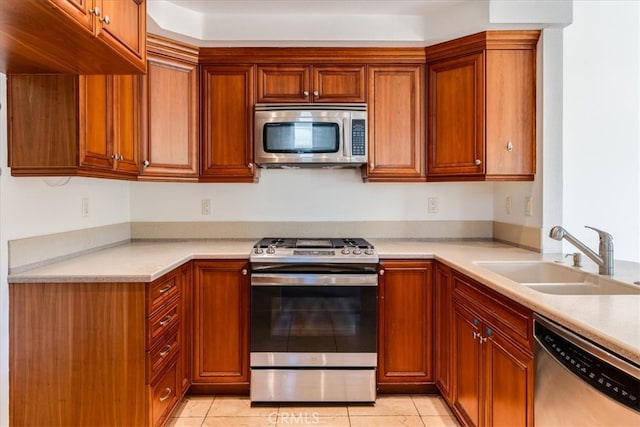 kitchen featuring appliances with stainless steel finishes, sink, and light tile patterned floors