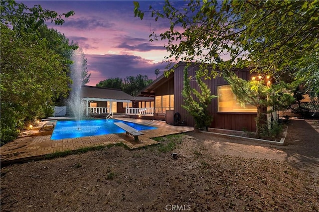 view of pool at dusk