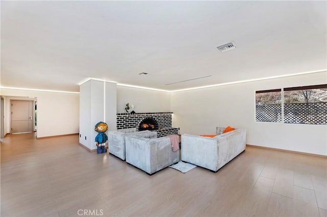 living room with a fireplace and light hardwood / wood-style flooring