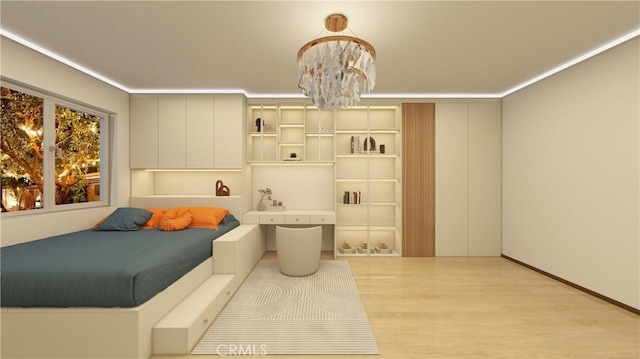 bedroom with light hardwood / wood-style flooring and a chandelier