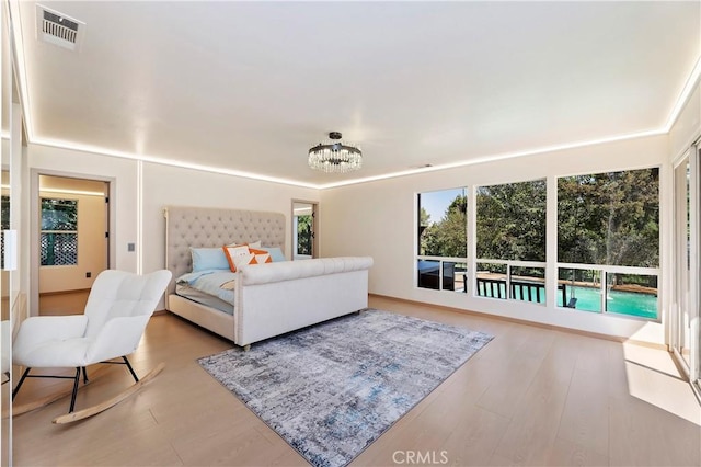 bedroom with a chandelier and hardwood / wood-style flooring