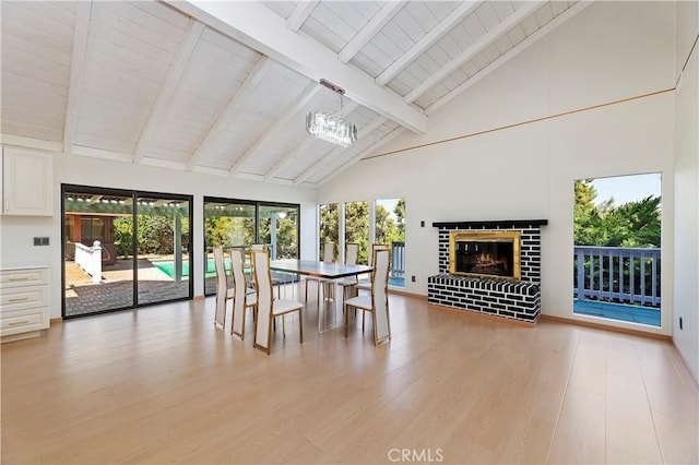 unfurnished sunroom featuring lofted ceiling with beams, an inviting chandelier, wooden ceiling, and a brick fireplace