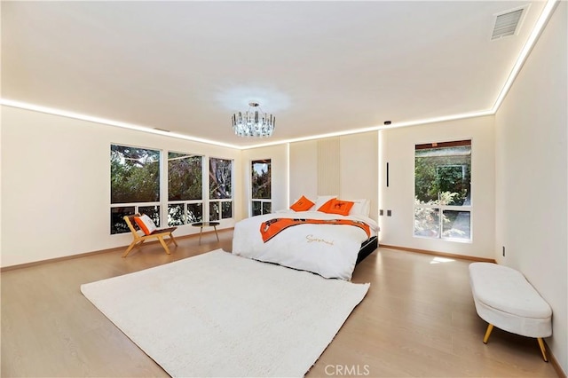 bedroom featuring a chandelier and hardwood / wood-style flooring