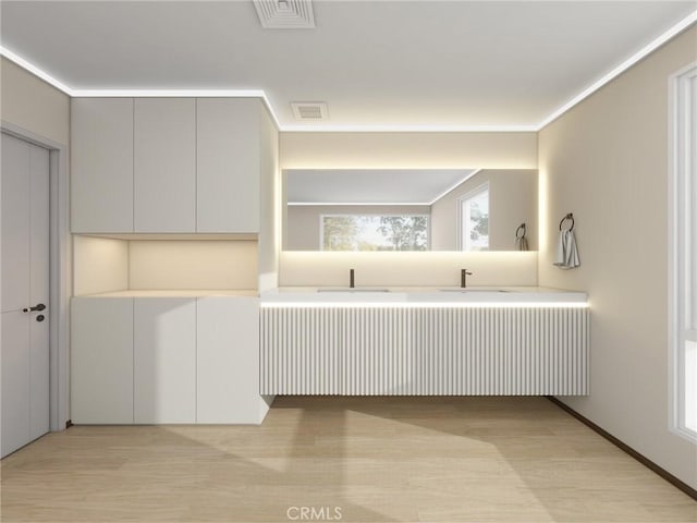 kitchen with kitchen peninsula, white cabinetry, and light hardwood / wood-style floors