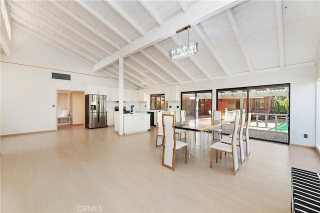 dining space featuring beamed ceiling, light wood-type flooring, high vaulted ceiling, and an inviting chandelier