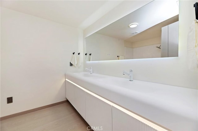 bathroom with vanity and hardwood / wood-style flooring