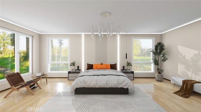 bedroom with light wood-type flooring, crown molding, and multiple windows