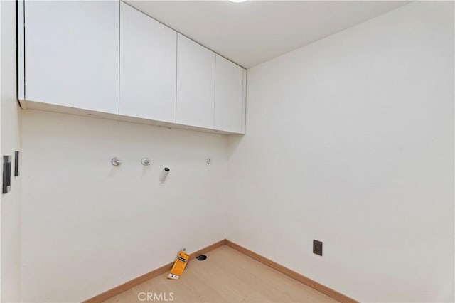 laundry area with cabinets