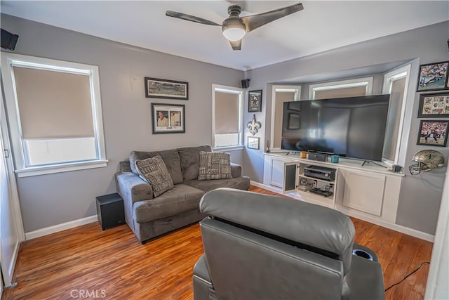 living room with ceiling fan and light hardwood / wood-style flooring