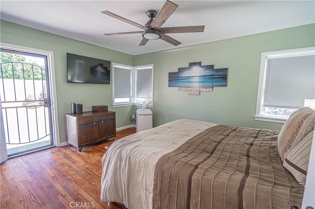 bedroom with ceiling fan, hardwood / wood-style floors, and access to outside