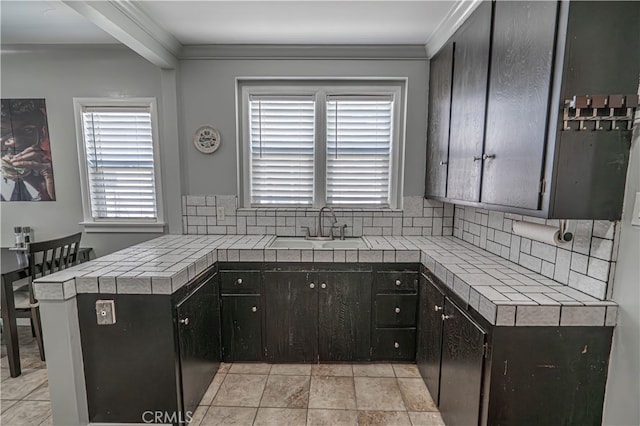 kitchen with plenty of natural light, tasteful backsplash, and tile countertops