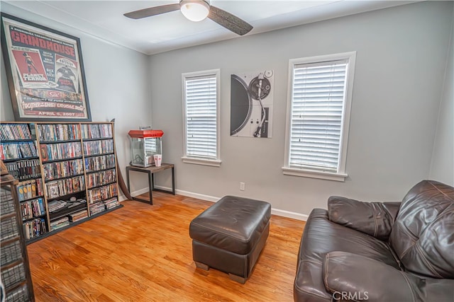 sitting room with ceiling fan and hardwood / wood-style floors