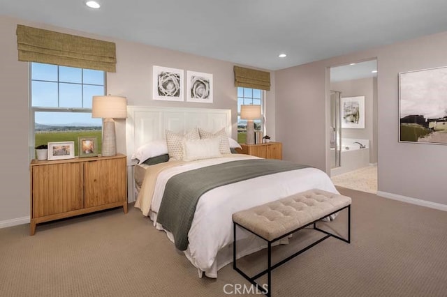 bedroom with light colored carpet and connected bathroom