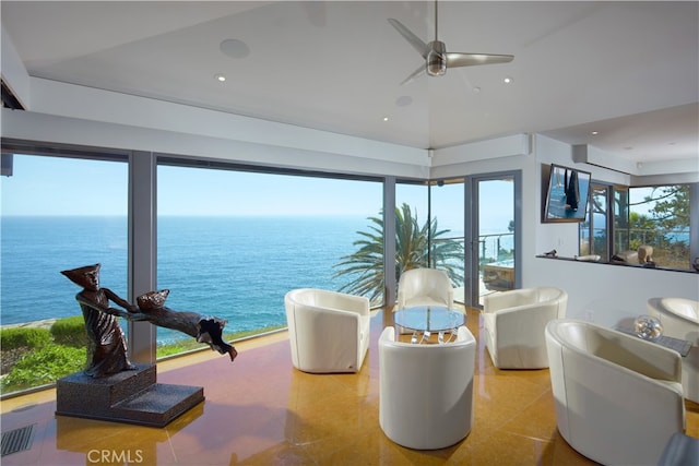 interior space featuring a water view and ceiling fan