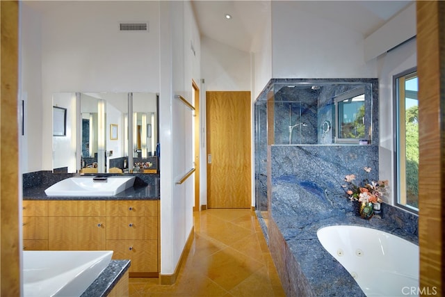 bathroom with tile patterned floors, vanity, and independent shower and bath