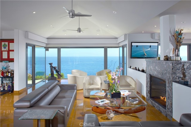 living room with lofted ceiling, a high end fireplace, light wood-type flooring, and ceiling fan