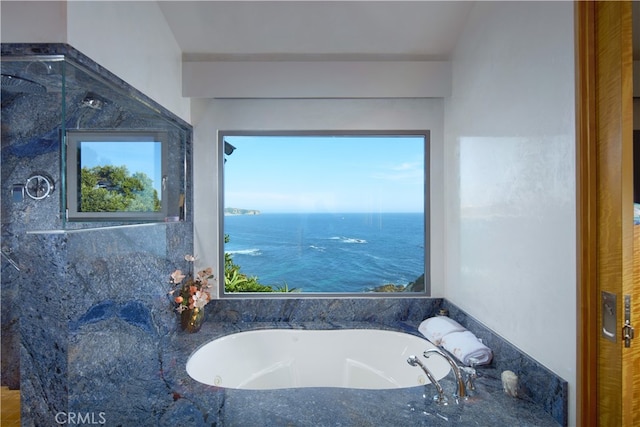 bathroom with a water view and separate shower and tub