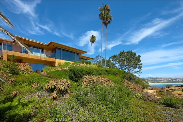 view of yard featuring a water view and a balcony