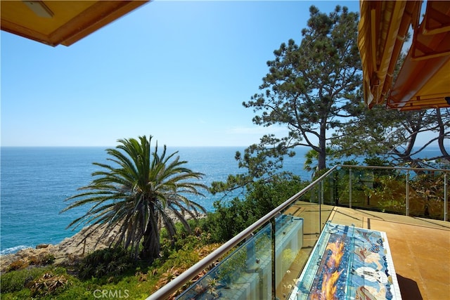 balcony featuring a water view