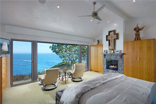 bedroom featuring a water view, beamed ceiling, carpet flooring, ceiling fan, and a premium fireplace