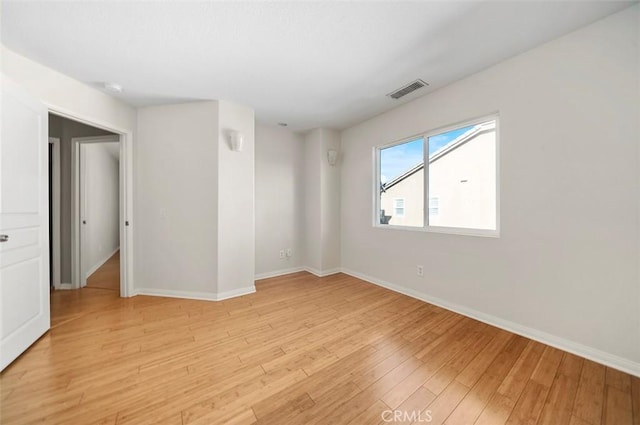 spare room featuring light hardwood / wood-style flooring