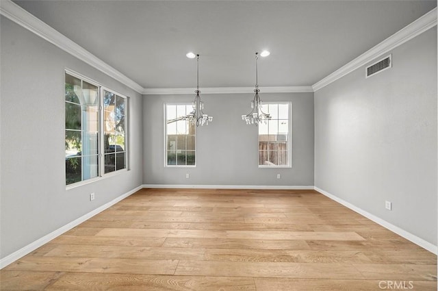 unfurnished dining area with a chandelier, a wealth of natural light, and ornamental molding