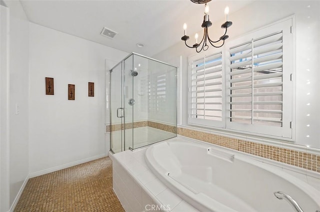 bathroom featuring tile patterned floors, plus walk in shower, and an inviting chandelier