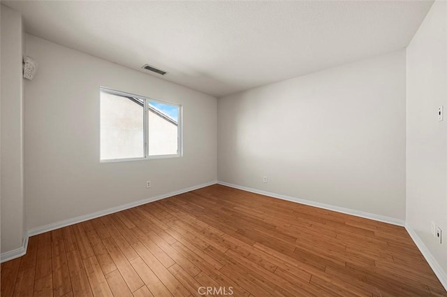 spare room featuring hardwood / wood-style flooring