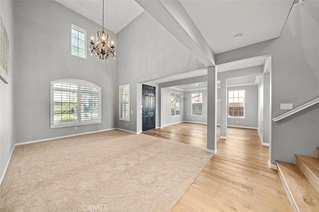 entryway featuring wood-type flooring and a chandelier