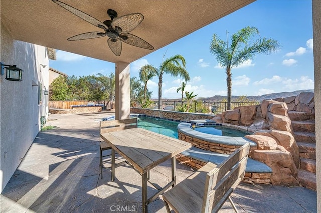 view of patio / terrace featuring a pool with hot tub and ceiling fan