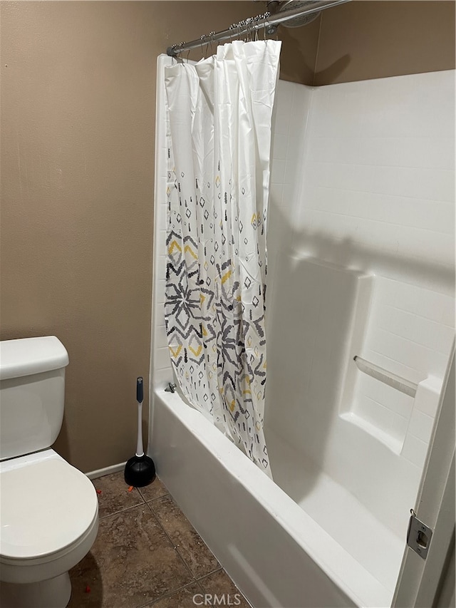 bathroom featuring toilet and shower / tub combo with curtain