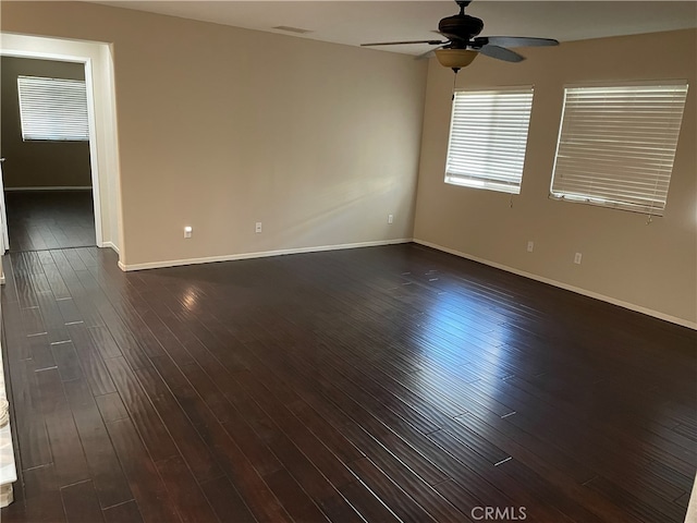 empty room featuring dark hardwood / wood-style floors and ceiling fan