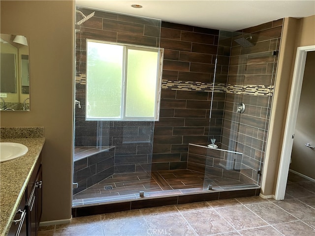 bathroom with vanity and a tile shower