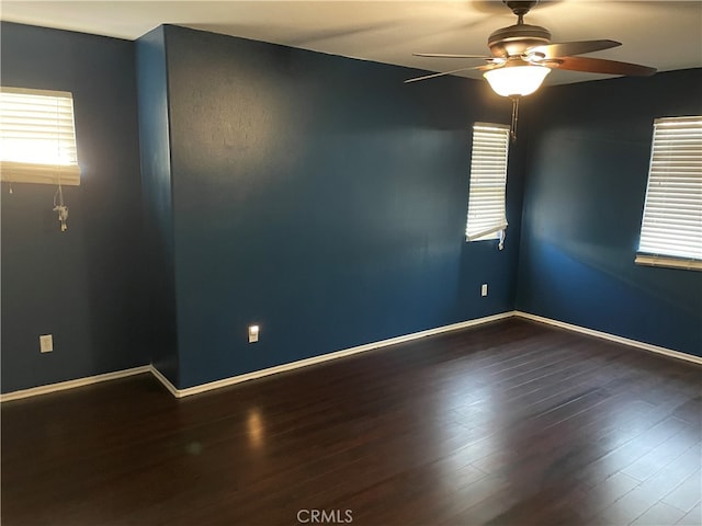 unfurnished room featuring ceiling fan and dark hardwood / wood-style flooring