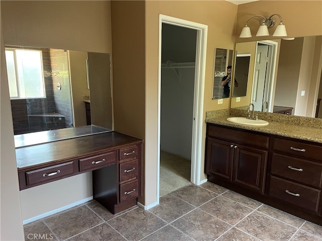 bathroom featuring vanity and tiled shower