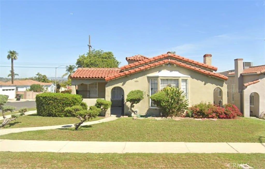 mediterranean / spanish-style home featuring a front lawn