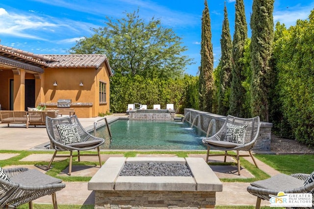 view of swimming pool featuring area for grilling, pool water feature, a fire pit, and a patio area