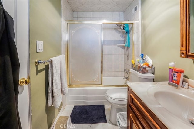 full bathroom with vanity, toilet, tile patterned flooring, and bath / shower combo with glass door