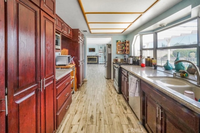 kitchen featuring light hardwood / wood-style flooring, stainless steel appliances, and sink