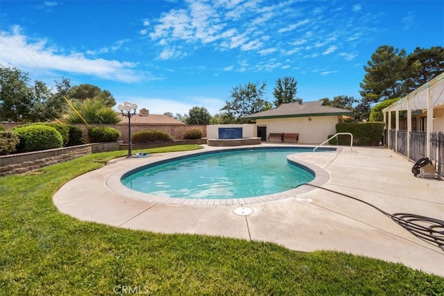 view of pool featuring a patio and a yard